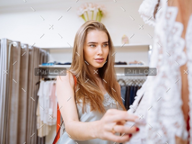 demo-attachment-141-woman-doing-shopping-and-choosing-clothes-in-PDEP6XU